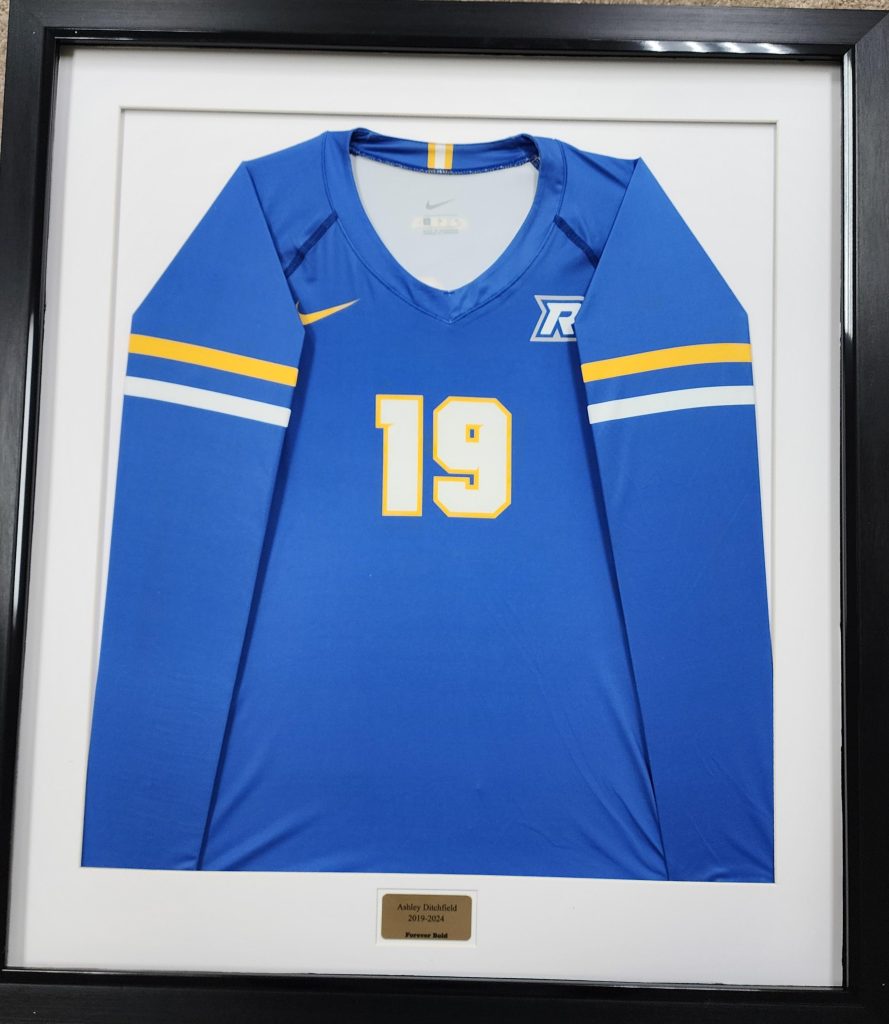 Framed blue sports jersey with number